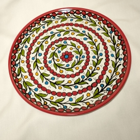 Plate with stem pattern spiraling and red circles with red flower in middle