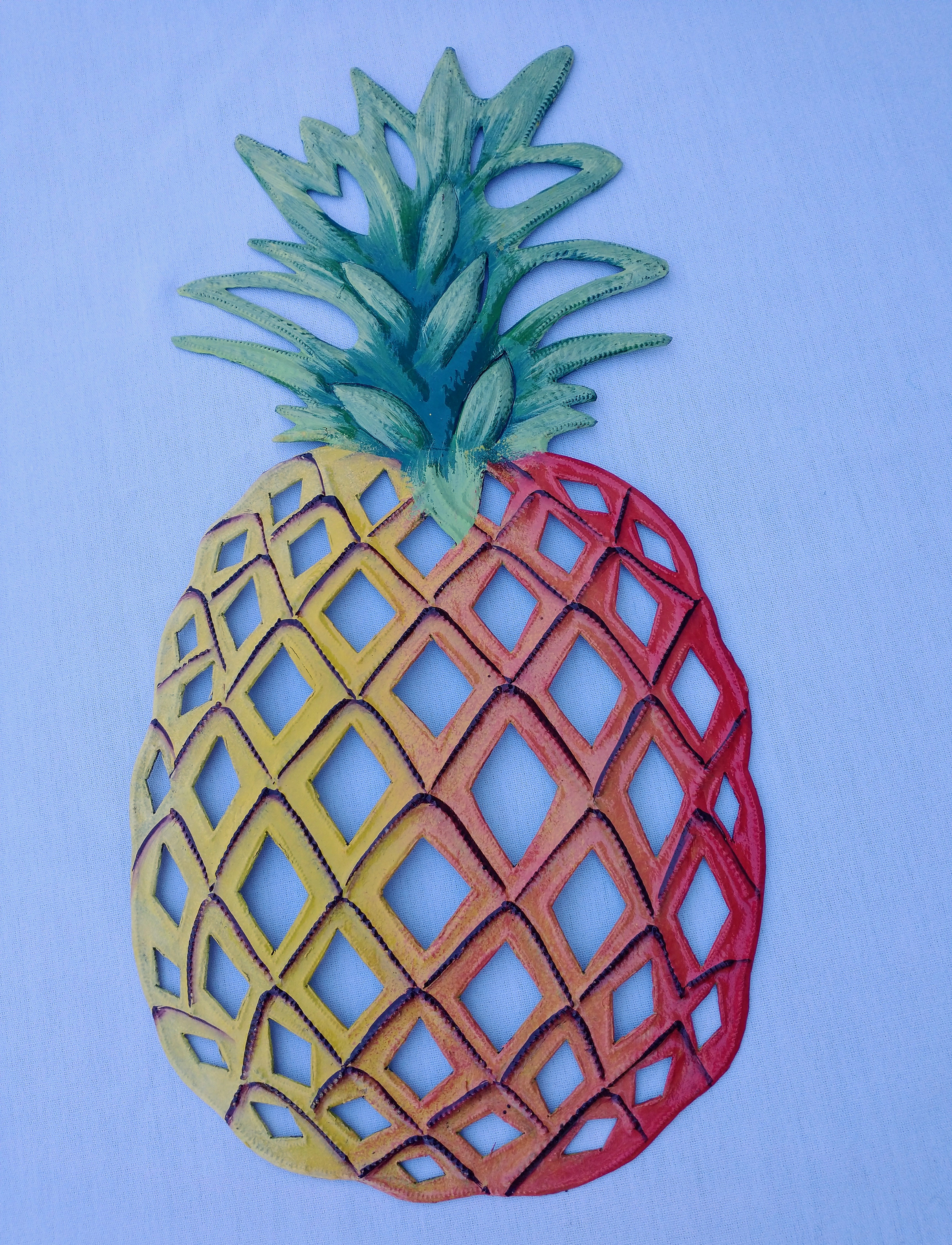 yellow, orange, and red with green top pineapple