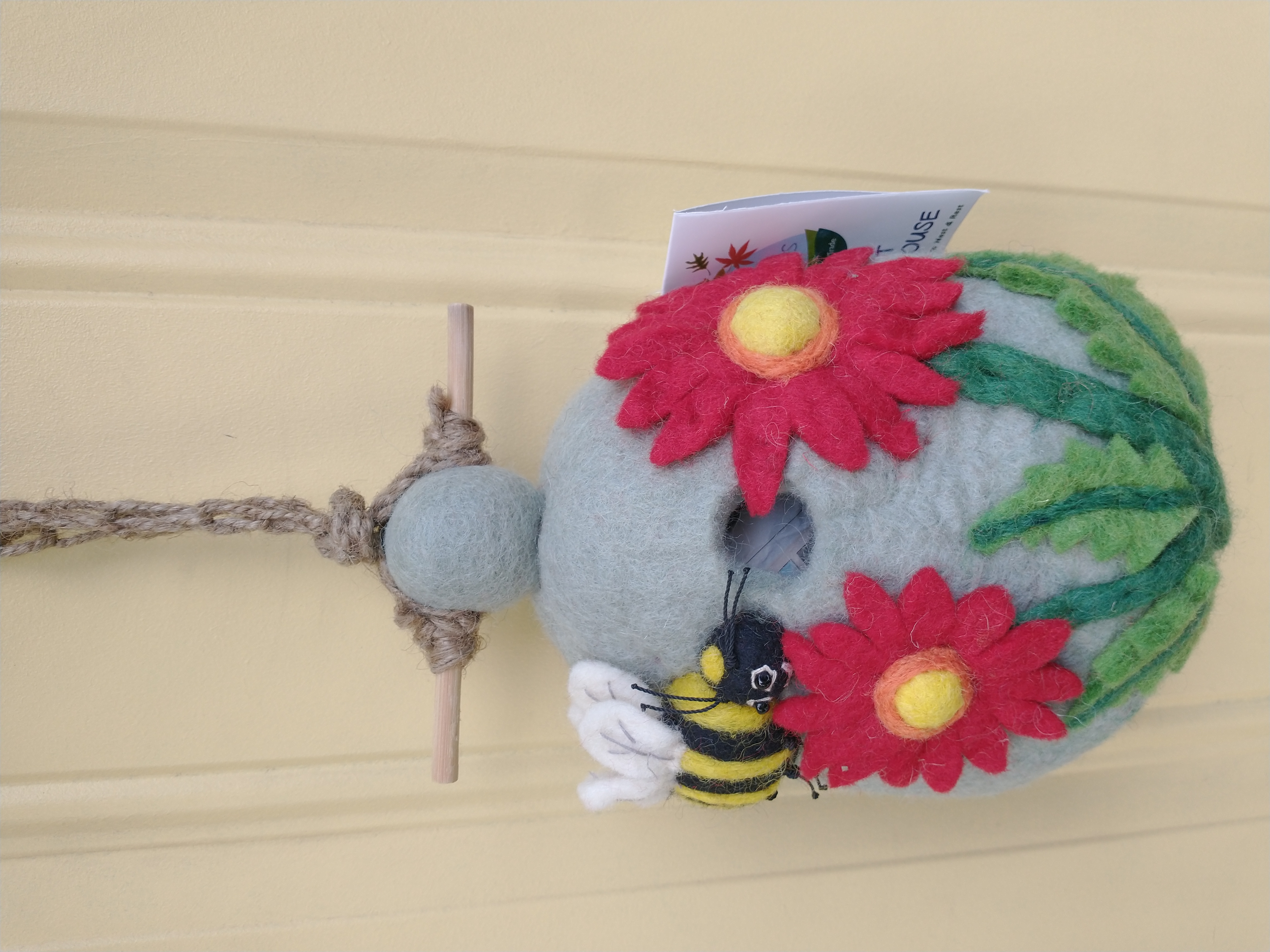 Bird house with bee and flowers