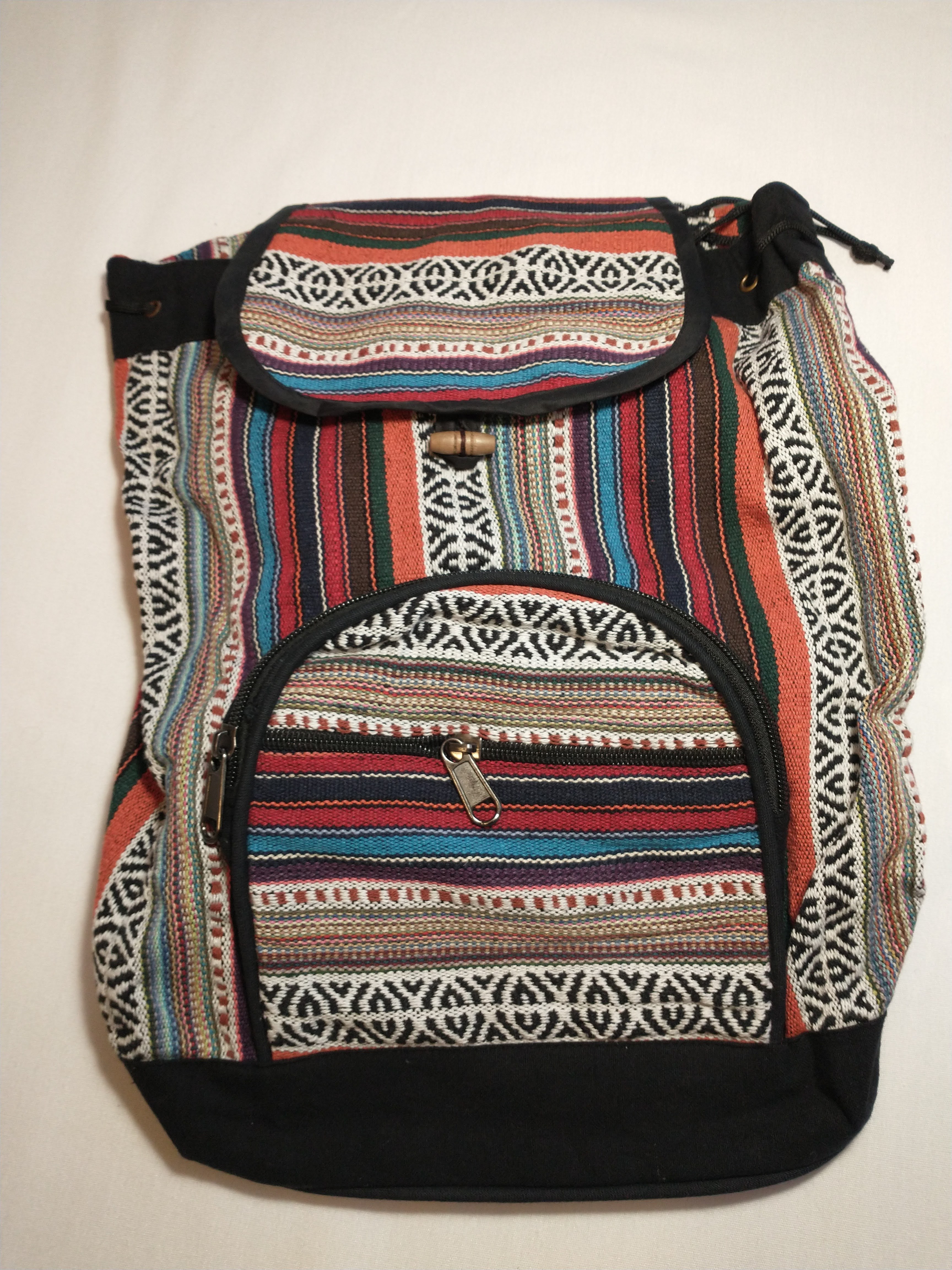 Pink, blue, orange, and black patterned backpack with front zipper