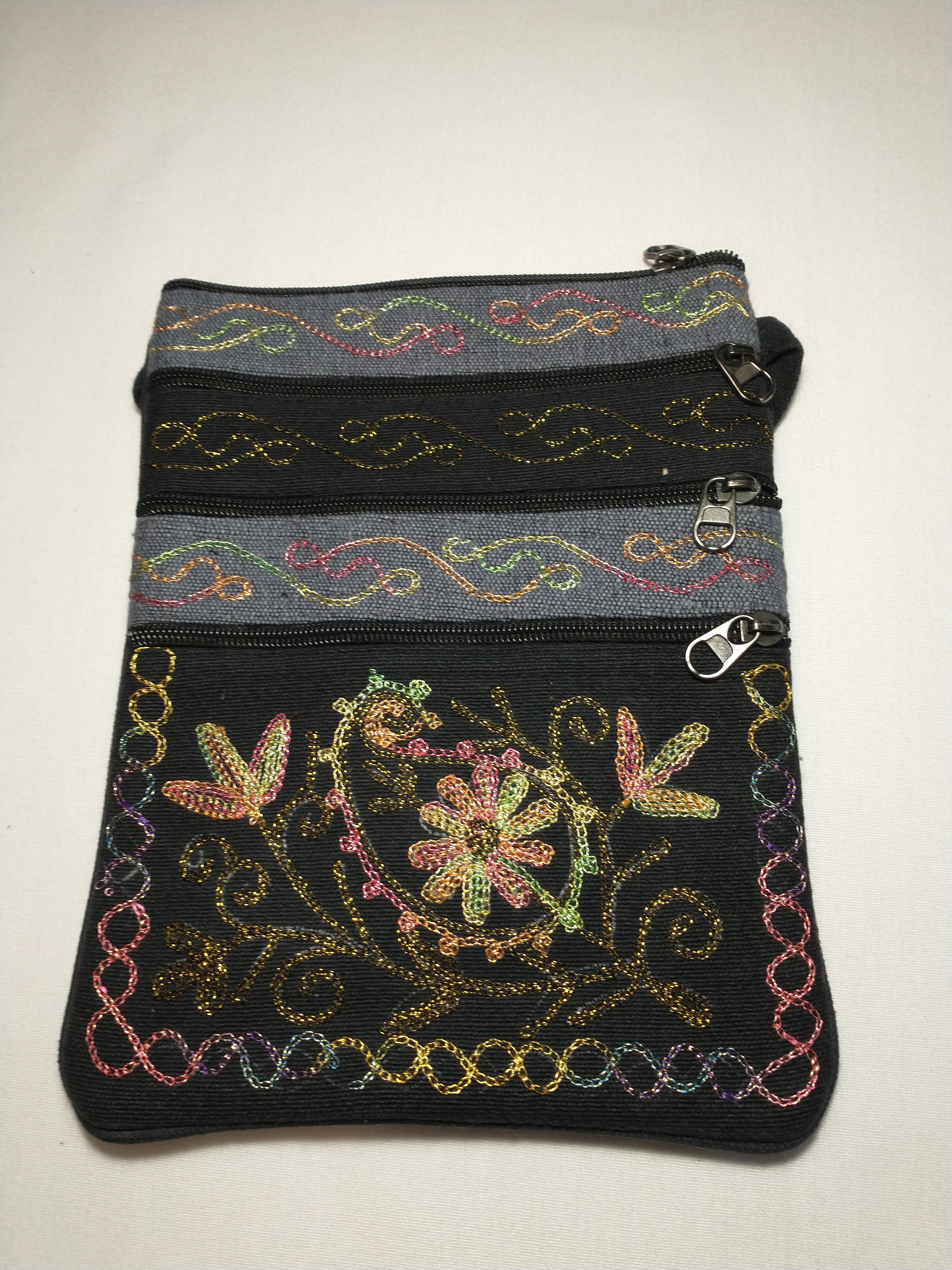 Black and gray purse with rainbow flower stitching