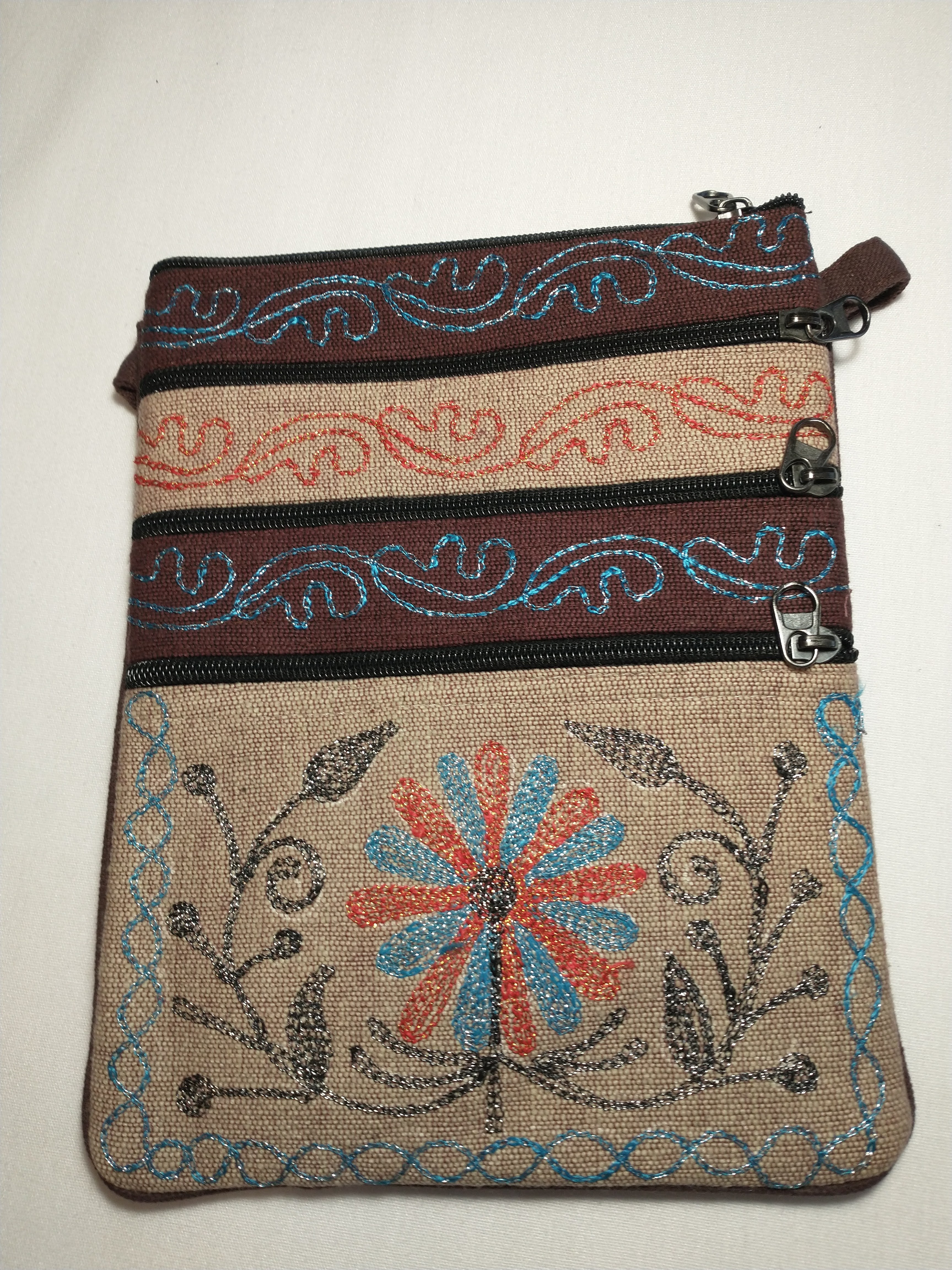 Brown and beige purse with blue and orange flower